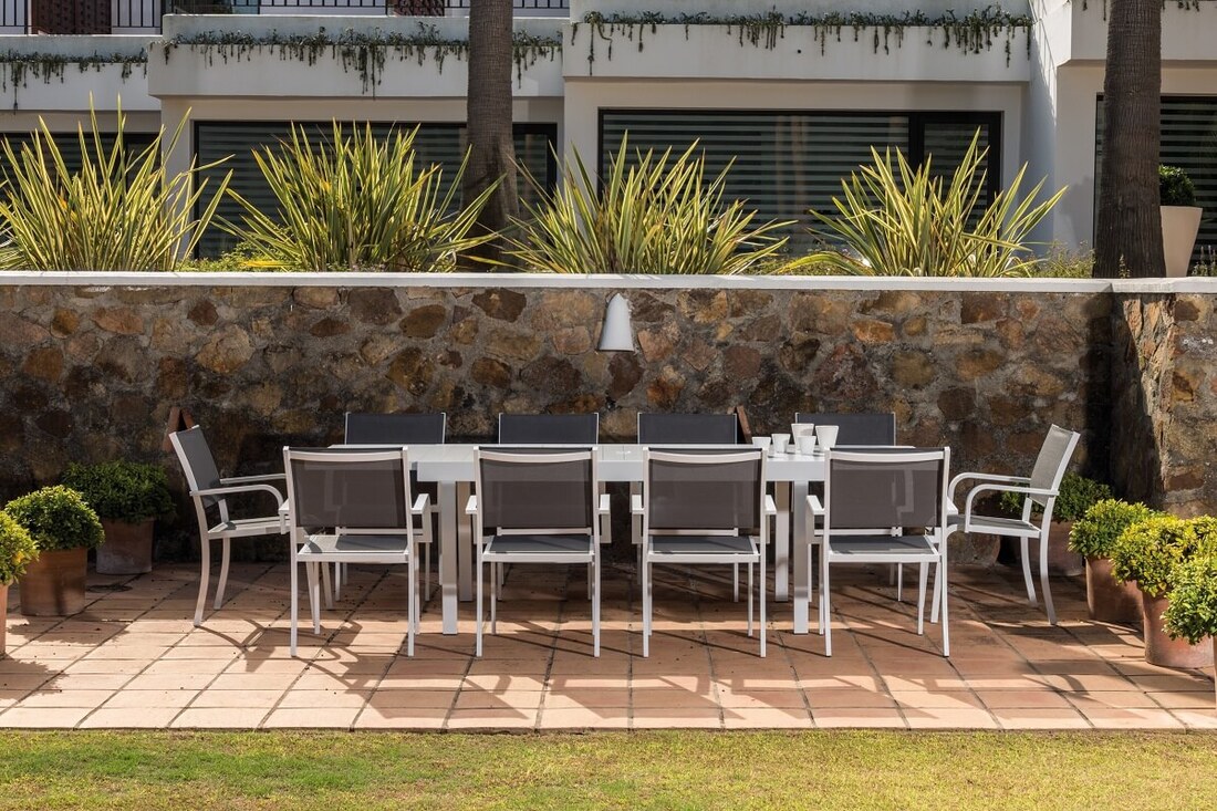 Outdoor extendable table and stackable chairs set in Cadiz
